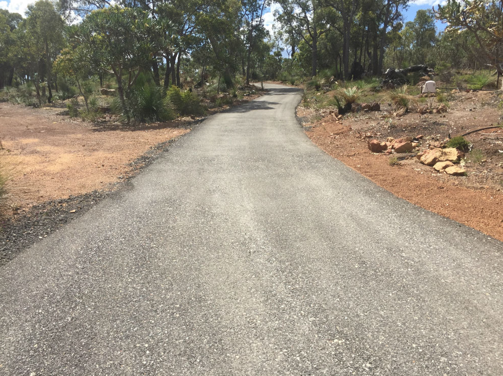 This is a photo of a hot spray & seal bitumen driveway which is in the process of being installed by Wattle Glen Surfacing Solutions