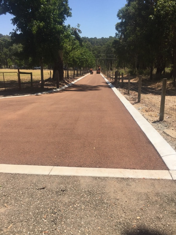 This is a photo of a hot spray & seal bitumen roadway which is in the process of being installed by Wattle Glen Surfacing Solutions